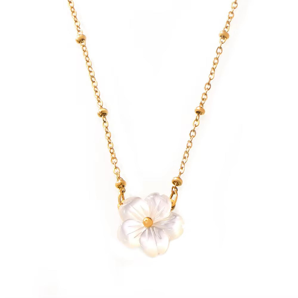 A delicate gold chain necklace featuring a central flower pendant made of iridescent white mother-of-pearl petals with a small gold center, shown against a plain white background.