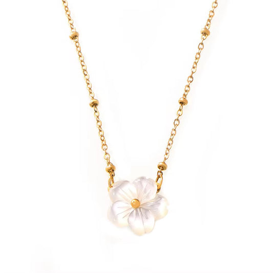 A delicate gold chain necklace featuring a central flower pendant made of iridescent white mother-of-pearl petals with a small gold center, shown against a plain white background.