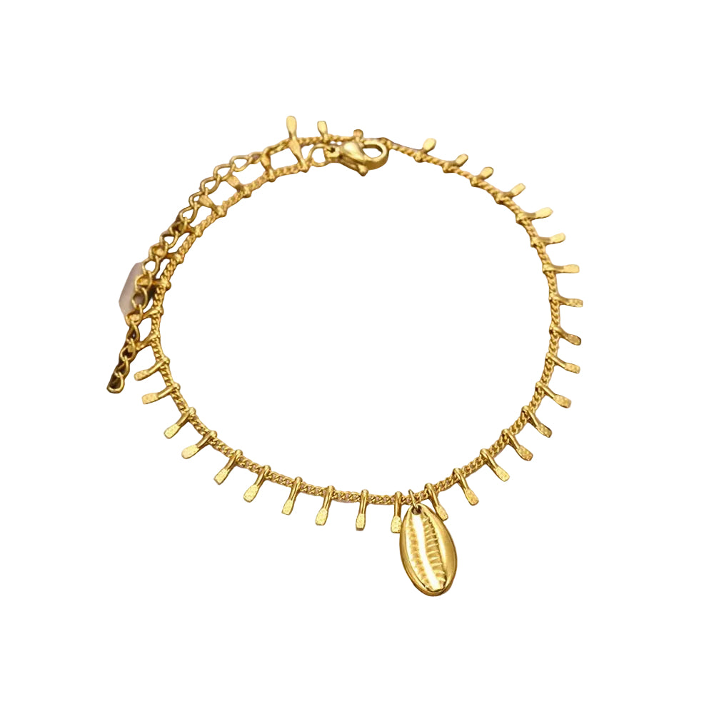 A gold chain anklet with dangling teardrop charms and a cowrie shell pendant, displayed inside a beige jewelry box.