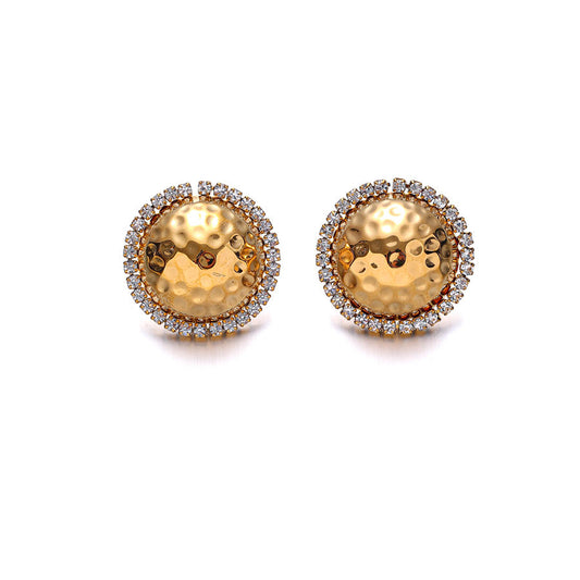 A pair of gold round stud earrings featuring a hammered center with a halo of small clear stones, photographed on a clean white background.