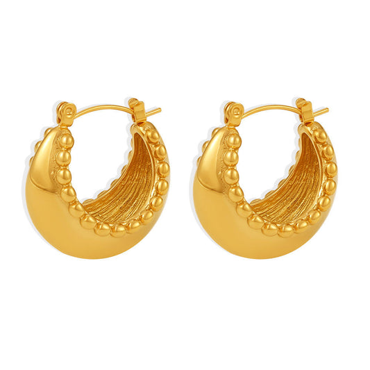 Gold hoop earrings on a white background