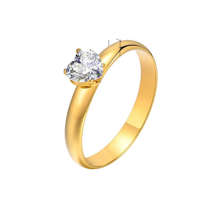 Gold ring with a clear gemstone on a white background
