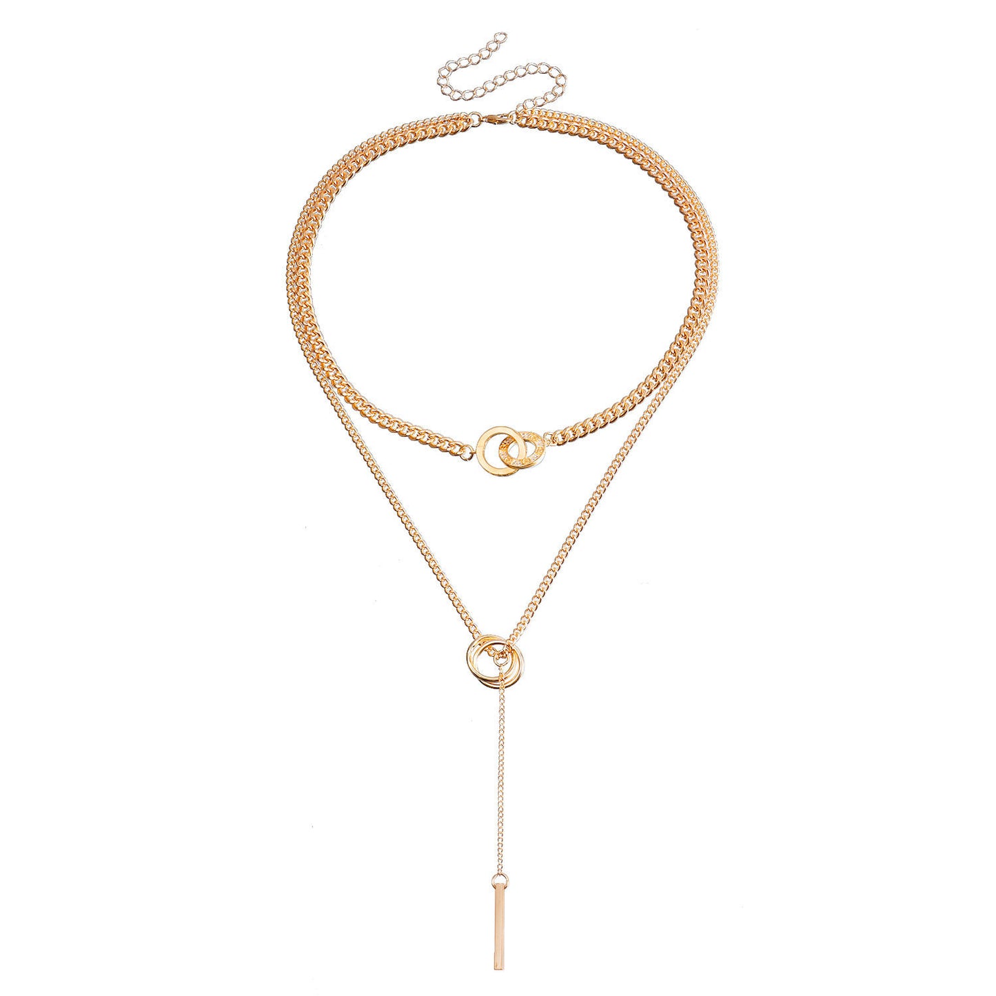 A gold-toned multi-layer necklace featuring a thick curb chain, a delicate chain with a small interlocking ring, and a long lariat drop ending in a flat bar, displayed on a solid white background.